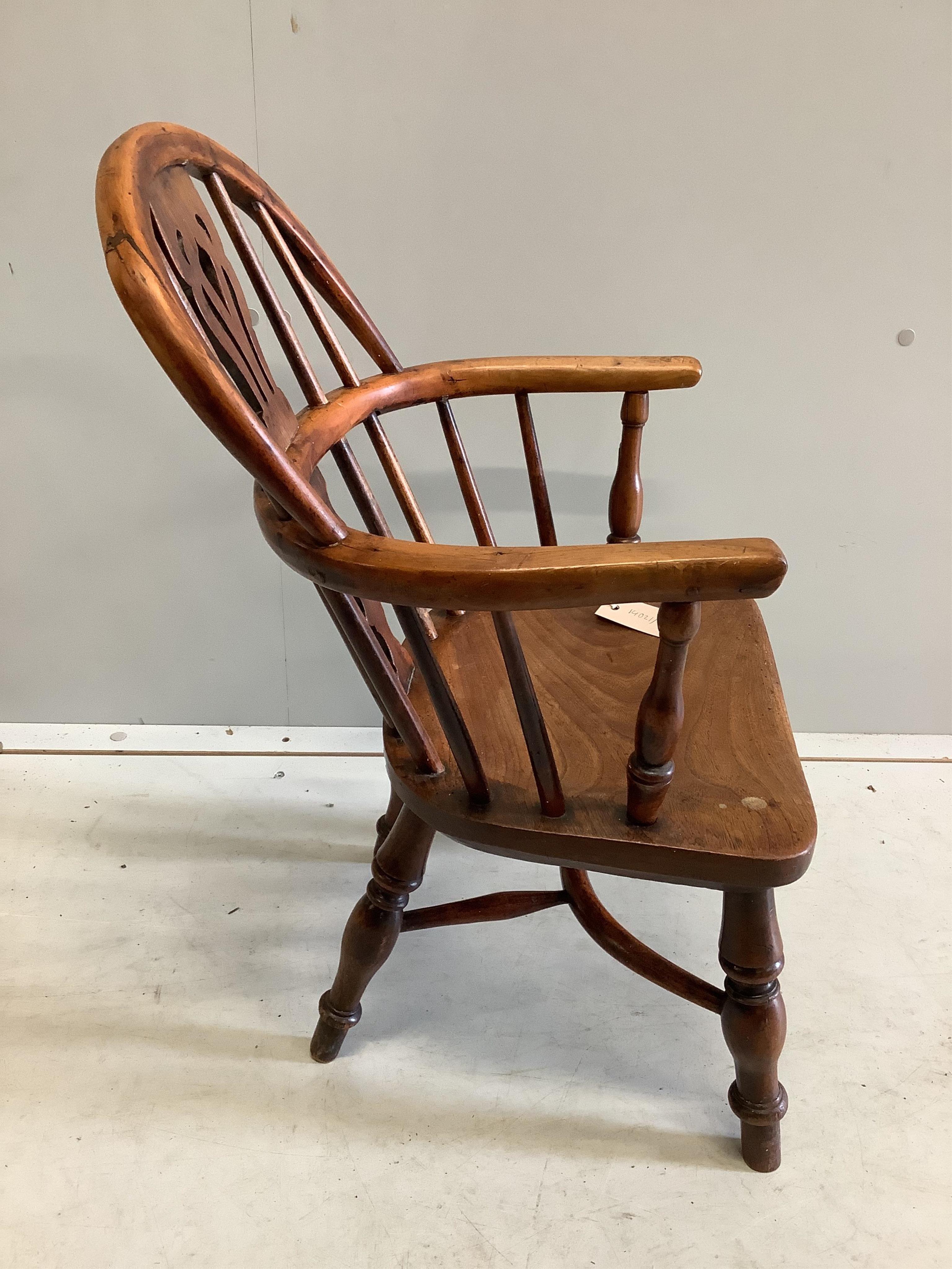 A 19th century yew and elm child's Windsor elbow chair, stamped 'Prior', width 38cm, depth 30cm, height 68cm